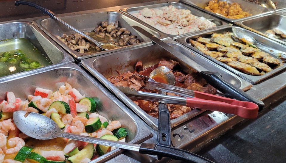 Self-serve buffet line with hot dishes.